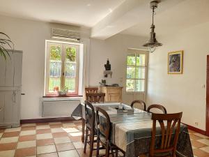 a kitchen and dining room with a table and chairs at Ferme de Mouline in Sainte-Foy-la-Longue