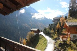 a view from a balcony of a mountain with a road at Matti-Tinoll in Grimentz