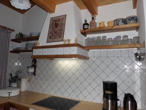 a kitchen with wooden shelves and a counter top at Matti-Tinoll in Grimentz +4 photos