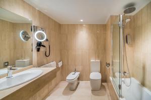 a bathroom with a toilet and a sink and a shower at Barceló Costa Vasca in San Sebastián