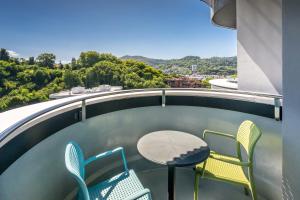 a patio with chairs and a table on a balcony at Barceló Costa Vasca in San Sebastián