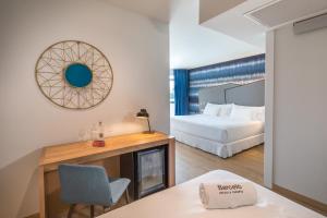a hotel room with a bed and a fireplace at Barceló Costa Vasca in San Sebastián
