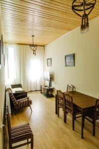 Home Kazbegi في كازباجي: غرفة معيشة مع طاولة وكراسي وأريكة