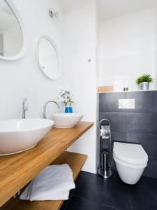 a bathroom with two sinks and a toilet at The Republic Apartments in Prague