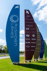 a group of surfboards standing in the grass at Chestnut Contractor Stays in Wellingborough