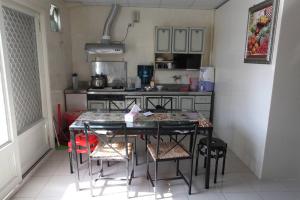 a small kitchen with a table and chairs in it at Good Day B&B in Fengli