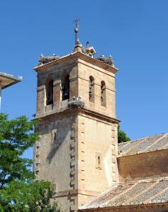 a tower of a building with a cross on top at Hotel Rural El Labrador in San Pedro de Gaíllos