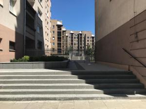 a set of stairs in a city with buildings at Lama Rooms in Warsaw