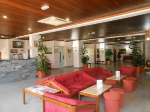 拉古什的住宿－Boutique Hotel Marina S. Roque，客厅配有红色的沙发和桌子