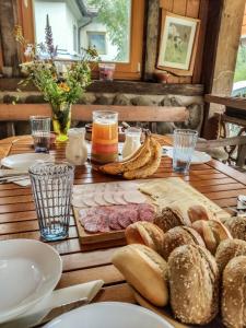 a wooden table with bread and other foods on it at Apartments Povh in Ljubno