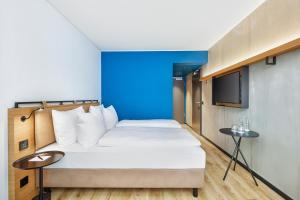 Postel nebo postele na pokoji v ubytování H2 Hotel Leipzig