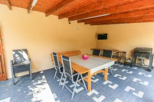 a dining room with a wooden table and chairs at NIKAS APARTMENT in Sibiu +42 photos