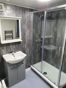a bathroom with a shower and a sink and a shower at Red Lion Rooms - Self Check In in Dalton in Furness