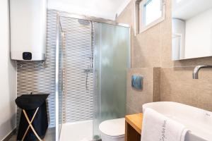 a bathroom with a shower and a toilet and a sink at CAPRARIA appartments in historic center, with private parking in Koper