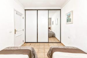 Łóżko lub łóżka w pokoju w obiekcie Apartamentos la Mar
