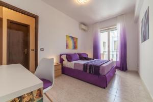 A bed or beds in a room at San Giovanni Apartment with Balcony