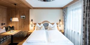 Posteľ alebo postele v izbe v ubytovaní Alpenhotel Kramerwirt