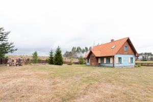 a house in the middle of a field at Dworek Sominy in Sominy