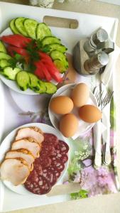 a table with plates of food with eggs beans and vegetables at 7 Sky on Shchorsa Street in Kyiv