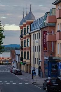 a city street with buildings and cars on the road at Clarion Collection Hotel Bristol in Arvika