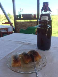 a plate of food on a table with a bottle of soda at Bungalovi Mijakovici in Pljevlja