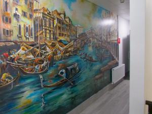 a mural on the wall of a room with boats at Abbey Court Hostel in Dublin