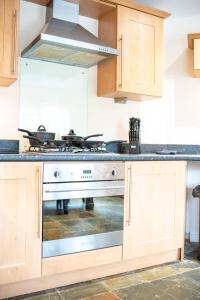 a kitchen with a stove top oven in a kitchen at Apartment 9 in Worksop