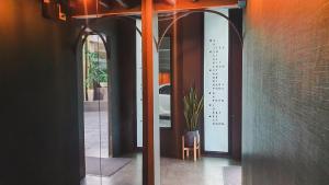 a glass door with a sign on the side of a building at Hotel Ordinary Bangkok in Bangkok