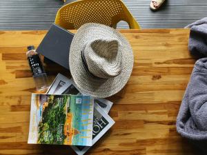 a hat and a magazine and a book on a table at Hotel Ordinary Bangkok in Bangkok +119 photos
