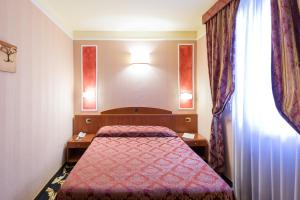 Postel nebo postele na pokoji v ubytování Boutique Hotel Puccini