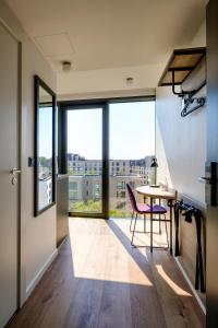 a room with a table, chairs and a window at Go Hotel City Apartments in Copenhagen