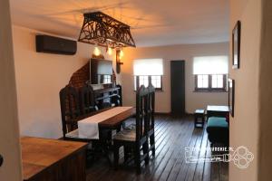 a dining room and living room with a table and chairs at Gotyk na dotyk z tarasem na dachu in Toruń