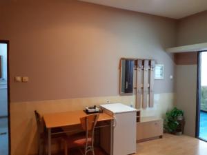 a kitchen with a wooden table and a table and chairs at Prenociste Pecinci in Pećinci