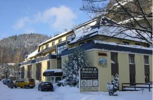 a building with a sign in front of it in the snow at Hotel Oybiner Hof in Oybin