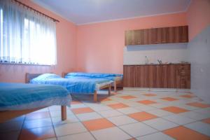 a large room with two beds and a kitchen at Prenociste Pecinci Biker Friendly in Pećinci