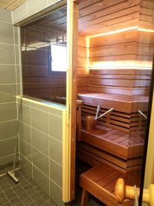 a bathroom with a sauna with a bench in it at PyhäBerry in Pelkosenniemi