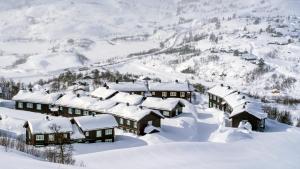 un pueblo cubierto de nieve en las montañas en Haukelifjell Skisenter en Vågsli
