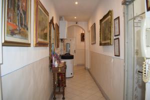 a hallway with paintings on the walls of a building at Soggiorno Santa Reparata in Florence