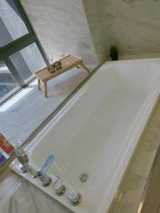 a bath tub with a cat sitting on top of it at Imperio Residence Bathtub Studio Melacca Town-FreeParking in Melaka