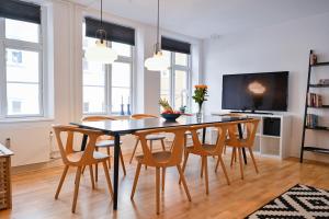 a dining room with a table and chairs at Sanders Tower - Chic Two-Bedroom Apartment In Charming Copenhagen in Copenhagen