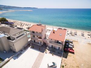 an aerial view of a beach with a building and the ocean at Xenia Suites in Limenaria