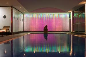 a man standing on a podium next to a swimming pool at Mercure Paris CDG Airport & Convention in Roissy-en-France