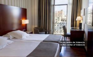 a hotel room with a bed and a balcony at Zenit Valencia in Valencia