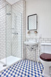 a bathroom with a toilet and a sink and a shower at The Priory Hotel in Newport