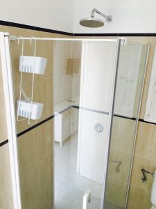 a bathroom with a shower with a glass door at Apartamentos La Fragata in Es Arenals