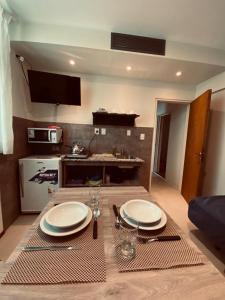 a kitchen with a table with plates and glasses on it at Hotel Riviera in Córdoba +7 photos