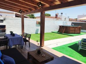 an outdoor patio with a table and a ping pong table at Novoasis in Chiclana de la Frontera