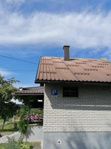 a building with a tile roof on top of it at Apartman Sunce in Ogulin