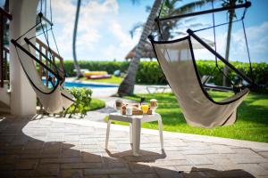 a table with drinks on it on a patio at Las Villas Akumal in Akumal