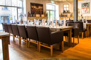 a dining room with a long table and chairs at Schloss Hotel Burgbrohl in Burgbrohl